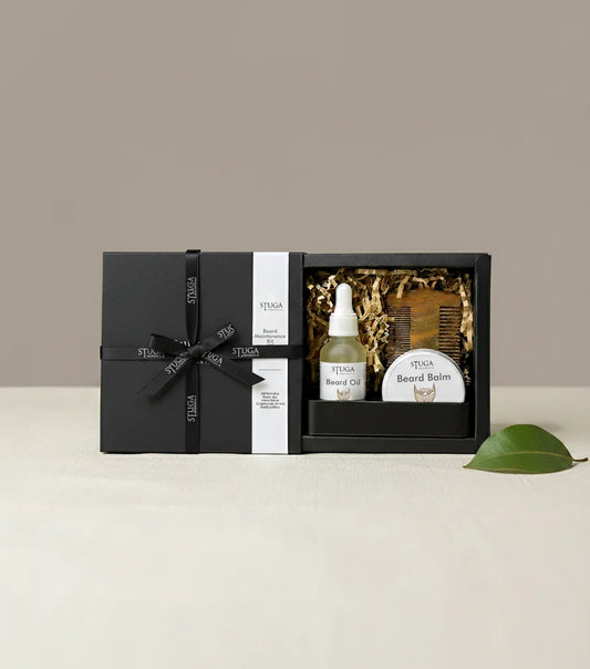 Stuga beard grooming kit in a black gift box, including beard oil, beard balm, and a wooden comb.