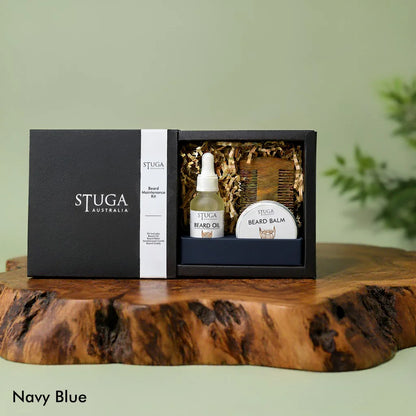 Stuga Australia Beard Maintenance Kit in navy blue box with beard oil, balm, and wooden comb on a wood slab.