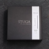 Stuga Classic shaving brush gift box, matte black with silver foil STUGA Australia logo and Classic Shaving Brush band, on dark slate.