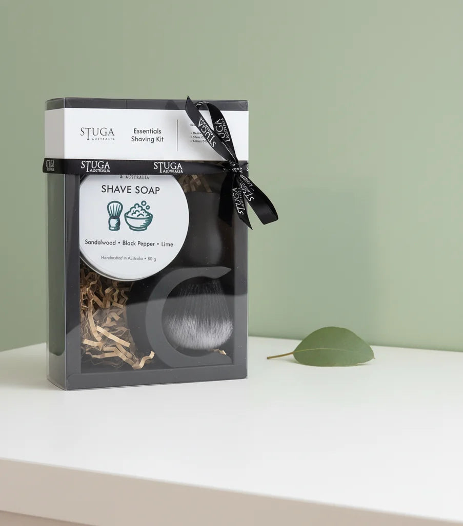 Stuga Essentials Shaving Kit with sandalwood, black pepper, lime shave soap, and brush in clear packaging.