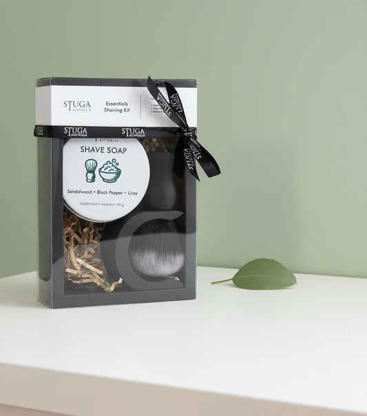 Stuga Essentials Shaving Kit with sandalwood, black pepper, lime shave soap, and brush in clear packaging.