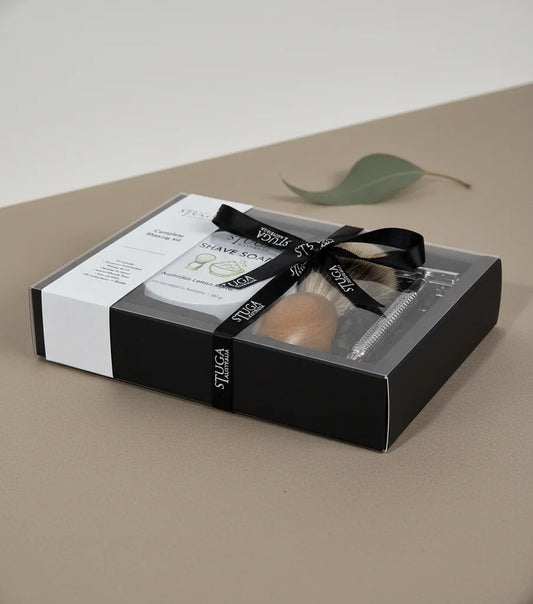 Stuga handmade complete shaving kit in a clear gift box with black ribbon, featuring a shaving brush, razor, and shave soap.