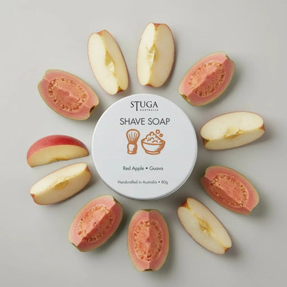 Stuga Australia Red Apple Guava Shave Soap in a white tin, surrounded by sliced red apples and pink guavas.