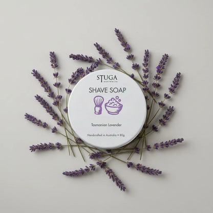 Stuga Australia Tasmanian Lavender Shave Soap in a white circular container, surrounded by dried lavender sprigs.