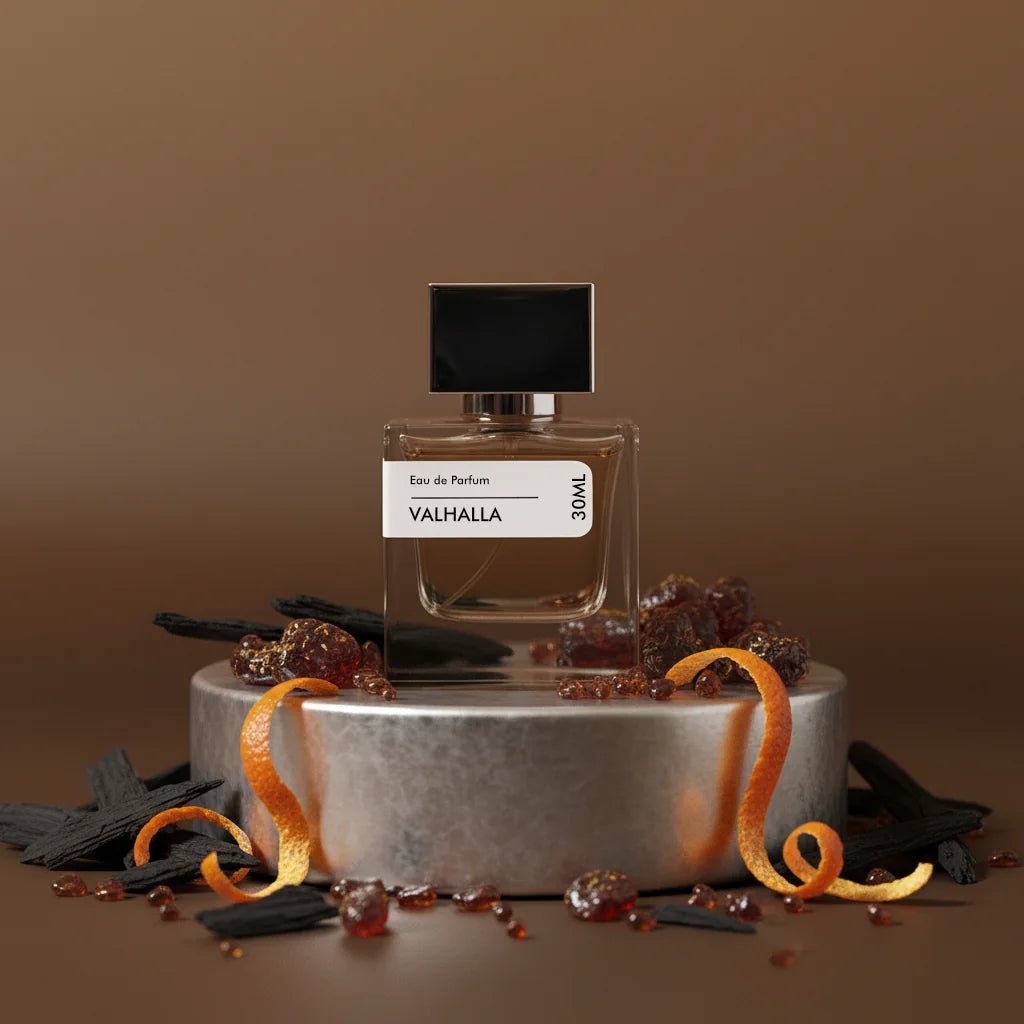 Stuga Valhalla Eau de Parfum 30ml bottle with black cap, surrounded by wood chips, amber resin, and orange peels on a silver 