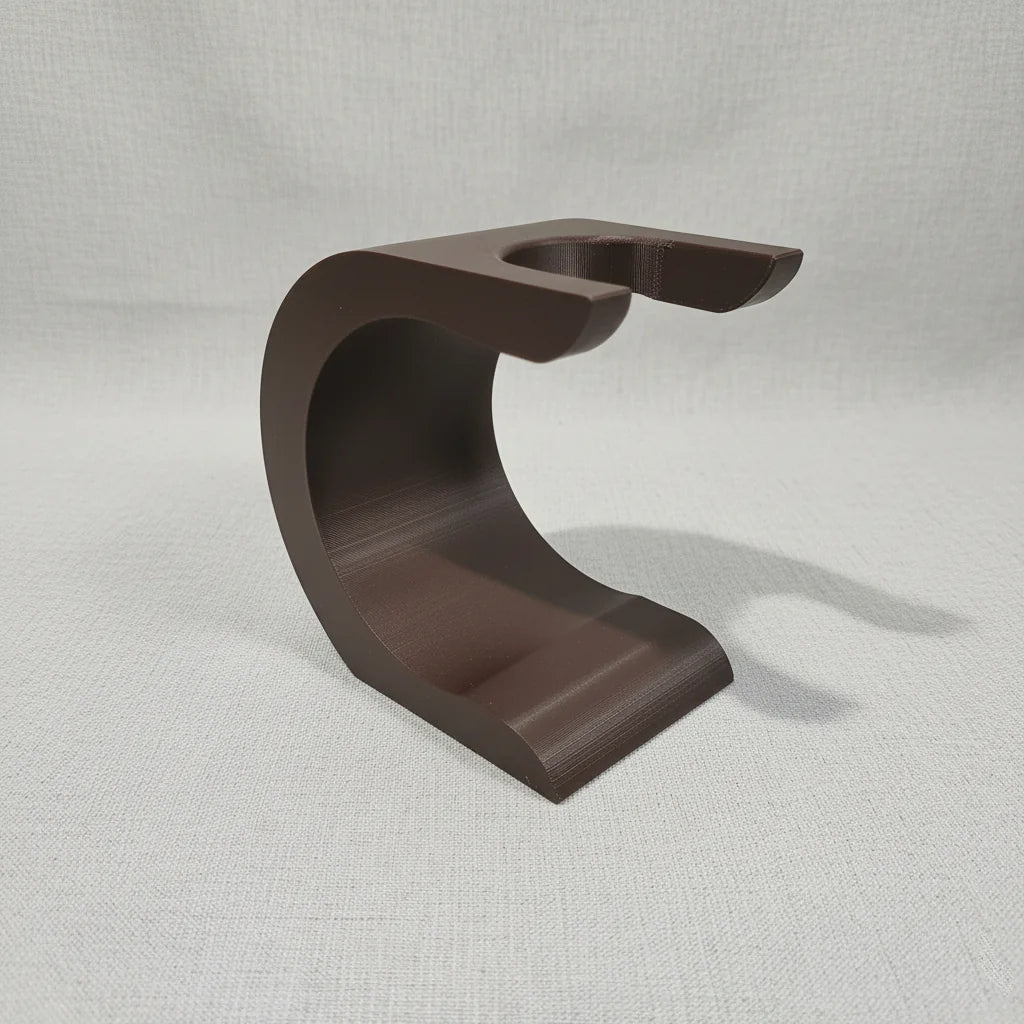 Brown Stuga Wave shaving brush stand with a curved, modern design, ideal for drying and displaying shaving brushes.