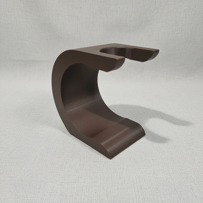Brown Stuga Wave shaving brush stand with a curved, modern design, ideal for drying and displaying shaving brushes.