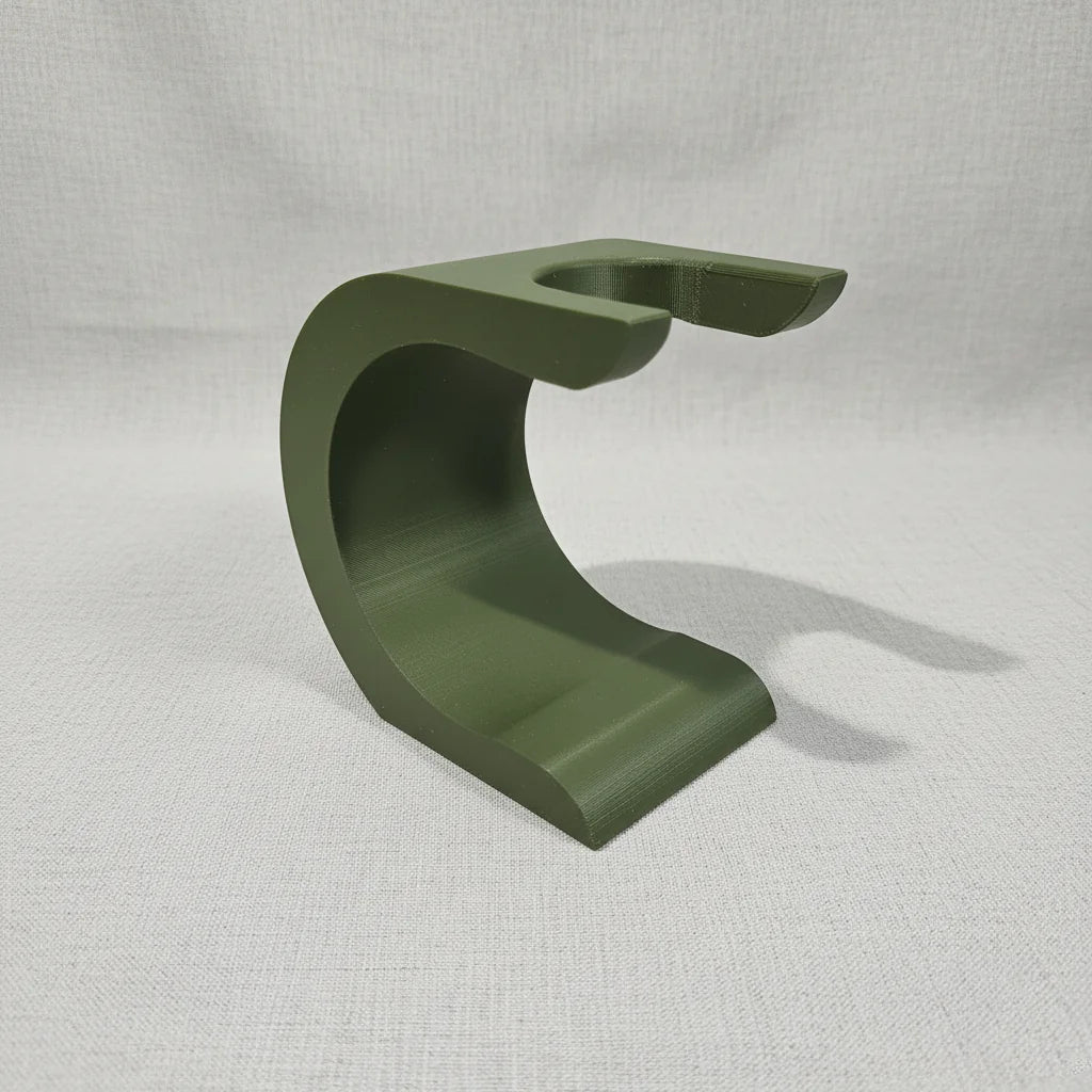 Stuga Wave shaving brush stand in matte olive green, featuring a modern curved design for elegant bathroom organization.