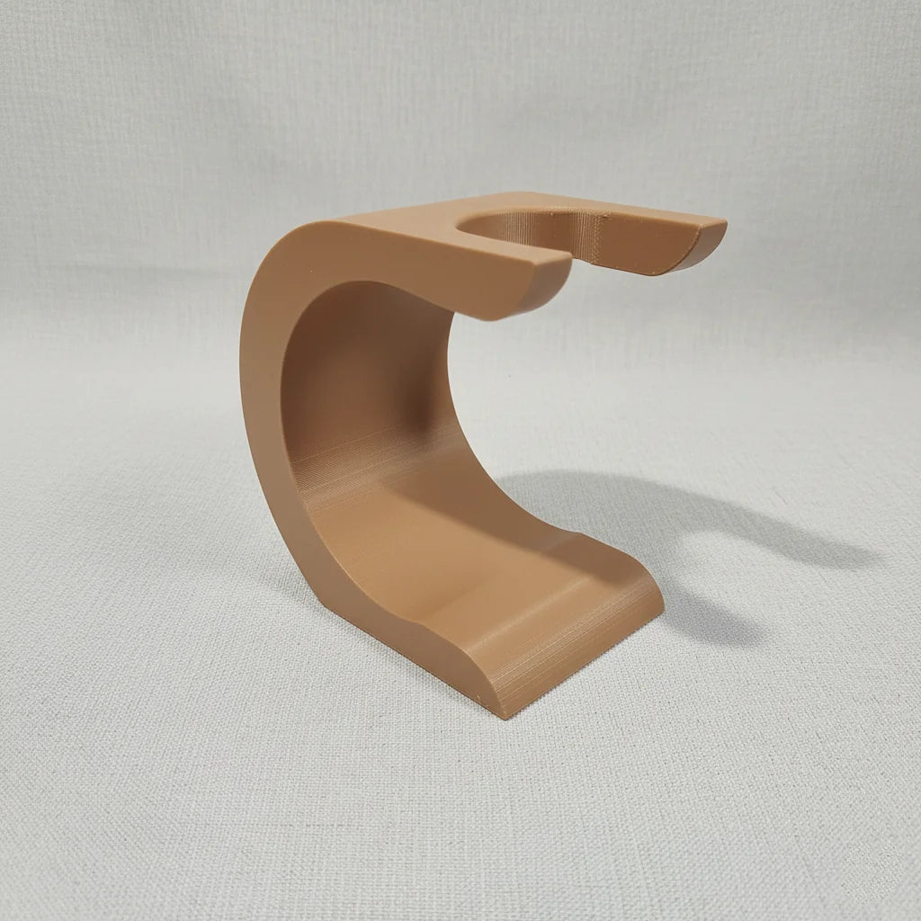 Stuga Wave shaving brush stand in a light brown, matte finish, designed to hold a shaving brush upside down for drying.