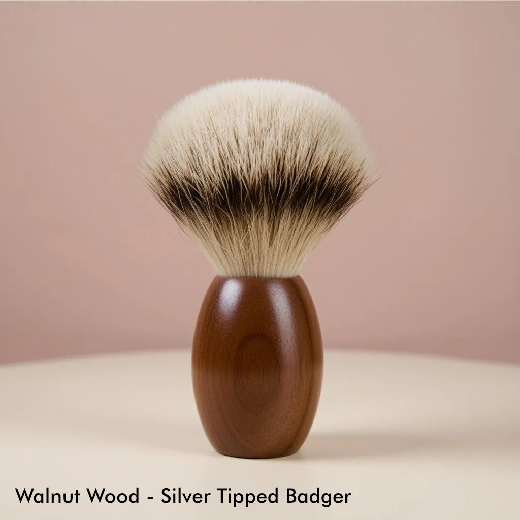 Elegant shaving brush with a rich walnut wood handle and soft, silver-tipped badger bristles, ideal for luxurious lathering.