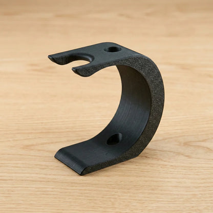 Black matte Wave XL shaving kit stand with curved design, featuring razor notch and brush holder on wooden surface